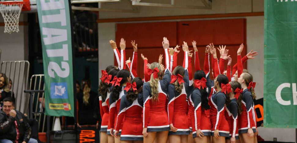 Cheerleading Squad with Hands Raised