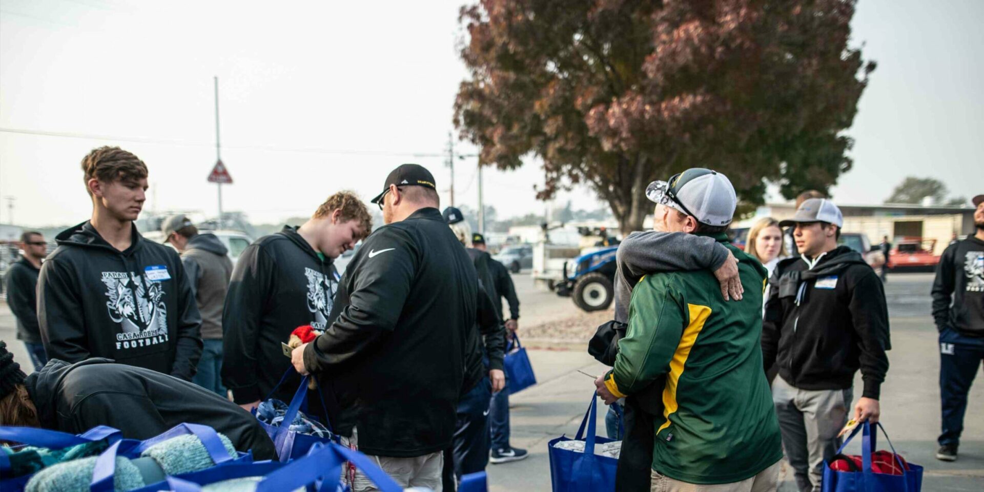 A care package is passed from one student to another. (Photo courtesy of the Casa Roble football team)
