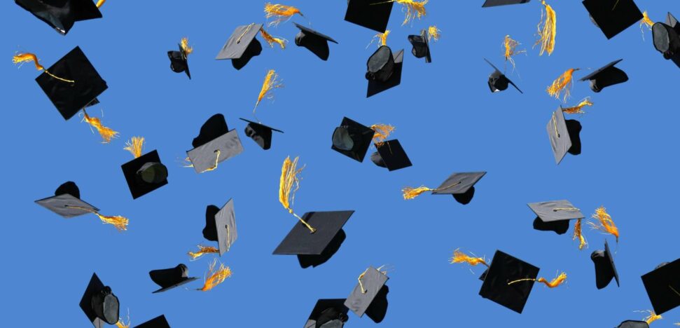 Graduation caps thrown in air