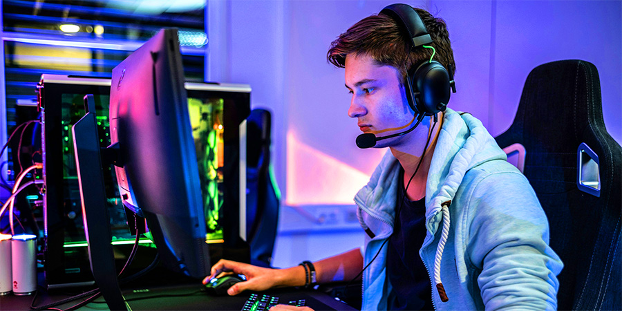 photograph of a student playing video games on a computer