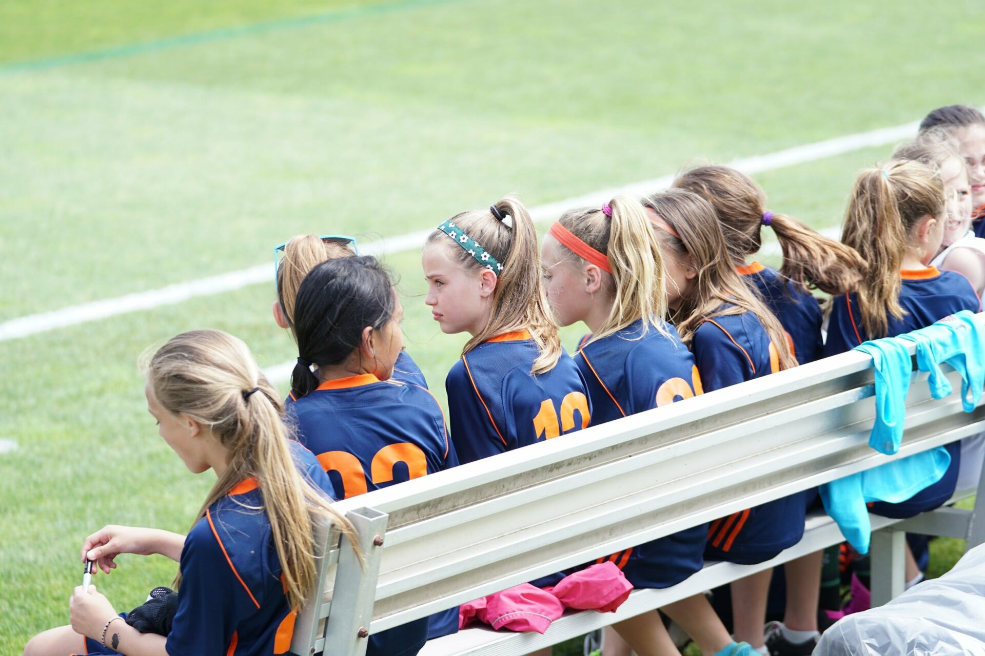 Girls athletic team sitting on bench